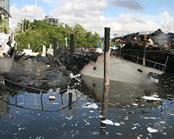 Image of a burned out boat taken from the front of the boat. This marine fire was investigated by Anderson Engineering and Investigations. Marine fire investigation by Anderson Engineering and Investigations.
